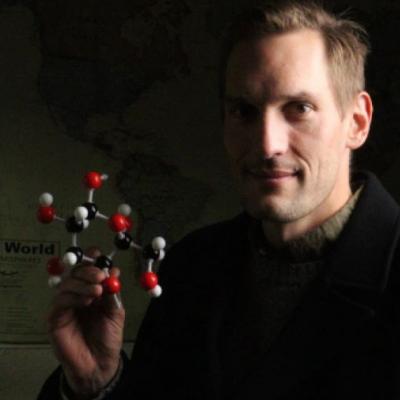 Jason with a model of a cellulose molecule, the most abundant organic compound on Earth, and one of the materials his company utilizes to deliver carbon-conscious alternatives to traditional design and structures. 