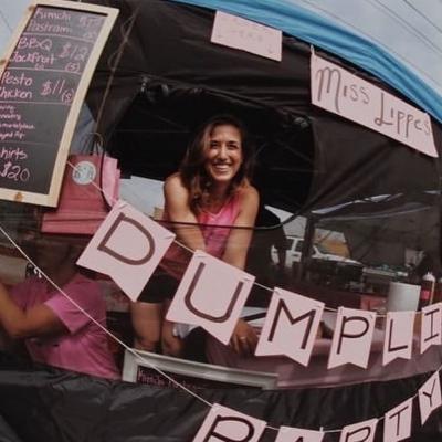 woman smiling from dumpling party food booth